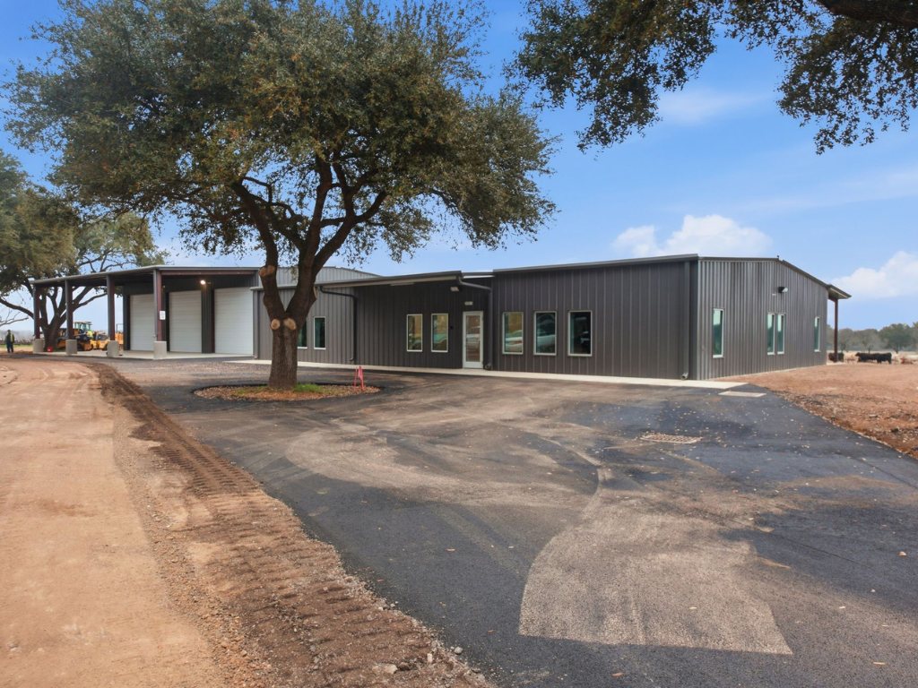 Wood frame commercial building under live oaks